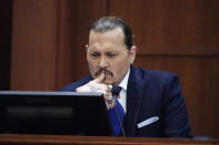 Actor Johnny Depp testifies in the courtroom at the Fairfax County Circuit Courthouse in Fairfax, Va., Monday, April 25, 2022. Depp sued his ex-wife Amber Heard for libel in Fairfax County Circuit Court after she wrote an op-ed piece in The Washington Post in 2018 referring to herself as a "public figure representing domestic abuse." (AP Photo/Steve Helber, Pool)