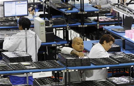 Workers assemble Motorola phones at the Flextronics plant that will be building the new Motorola smart phone "MotoX" in Fort Worth, Texas September 10, 2013. REUTERS/Mike Stone