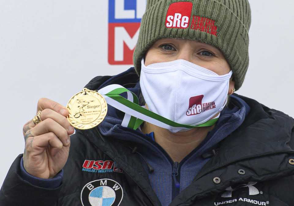 Canada's Kaillie Humphries of the United States holds the gold medal on the podium after her victory in the women's monobob race at the world cup in Altenberg, Germany, Saturday, Dec.4, 2021. (Robert Michael/dpa via AP)