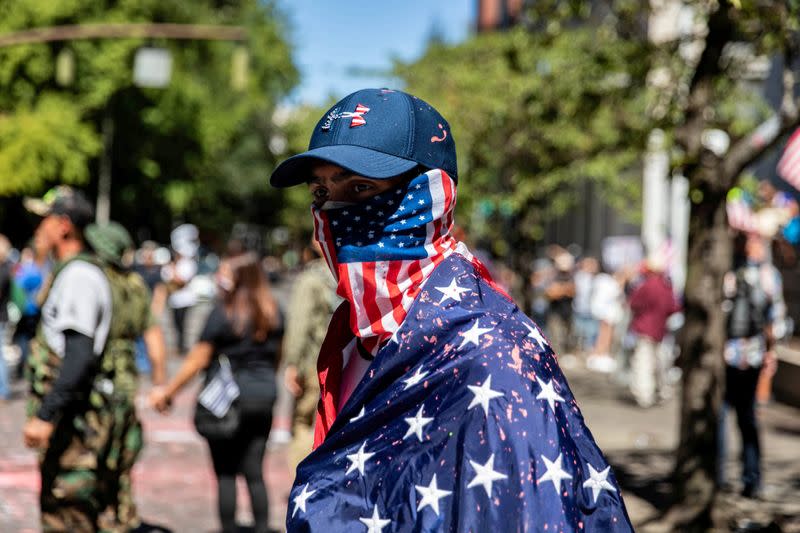 FILE PHOTO: A man dressed in an American flag joins protesters in Portland