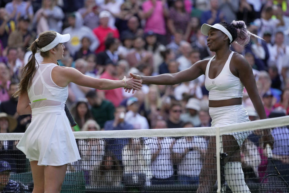 Ukraine's Elina Svitolina, left, greets Venus Williams of the US at the net after beating her in a first round women's singles match on day one of the Wimbledon tennis championships in London, Monday, July 3, 2023. (AP Photo/Kin Cheung)