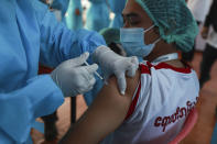 A volunteer heath worker receives a COVID-19 vaccine at the Ayeyarwaddy COVID treatment center, Wednesday, Jan.27, 2021, in Yangon, Myanmar. Health workers in Myanmar on Wednesday became the country's first people to get vaccinated against COVID-19, just five days after the first vaccine supply was delivered from India. (AP Photo/Thein Zaw)