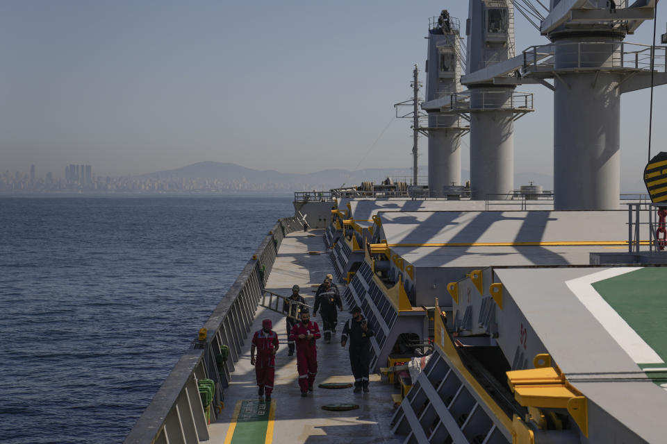 FILE - Crew members of the cargo ship Med Island, which came from Ukraine loaded with grain, prepare the ship for inspection by U.N. officials, while it is anchored in the Marmara Sea in Istanbul, Turkey, on Oct. 1, 2022. Russia has suspended its part of the deal allowing Ukraine to ship grain from its Black Sea ports safely amid a months long war, and it appears that the remaining partners are now left to take their chances. (AP Photo/Khalil Hamra, File)