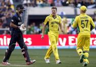 Australia's wicketkeeper Brad Haddin (R) celebrates with team-mate James Faulkner (C) after dismissing New Zealand's Grant Elliott (L) for 83 runs during their Cricket World Cup final match at the Melbourne Cricket Ground (MCG) March 29, 2015. REUTERS/Jason Reed