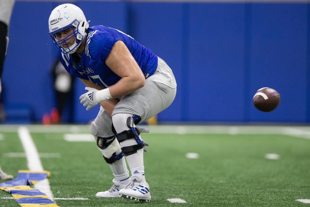 Kansas football offensive lineman Dominick Puni (67) practices with the Jayhawks in 2023.