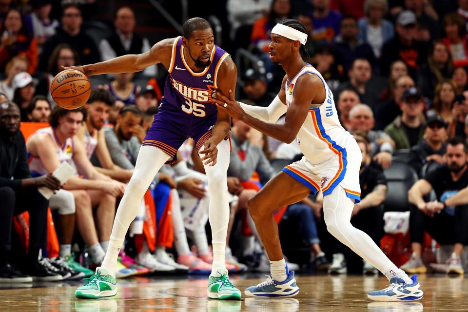 Suns forward Kevin Durant (35) handles the ball against Thunder guard Shai Gilgeous-Alexander (2) during the second quarter at Footprint Center on March 3 in Phoenix.