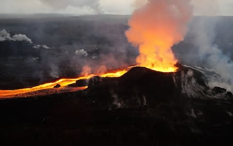 An early morning view of fissure 8 and lava channel looking toward the east - Credit: AFP