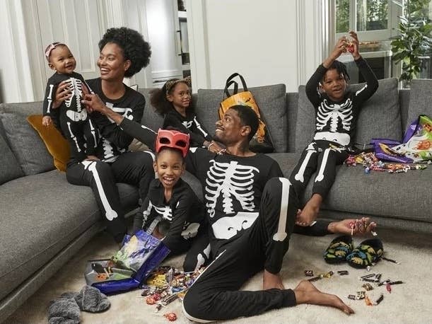 A family wears matching halloween jammies