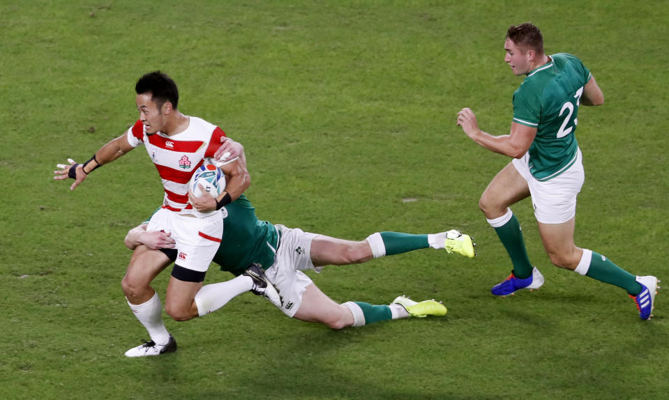 Japan's Kenki Fukuoka runs past Ireland's defense during the Rugby World Cup Pool A game at Shizuoka Stadium Ecopa between Japan and Ireland in Shizuoka, Japan, Saturday, Sept. 28, 2019. (Kyodo News via AP)