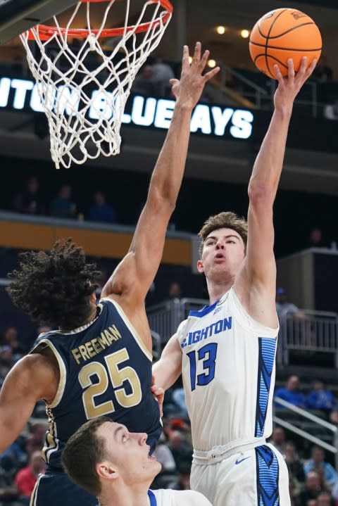 Creighton’s Mason Miller (13) shoots over Akron’s Enrique Freeman (25) during the second half of a first-round college basketball game in the NCAA Tournament, Thursday, March 21, 2024, in Pittsburgh. (AP Photo/Matt Freed)