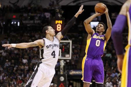 Los Angeles Lakers forward Nick Young (0) shoots the ball over San Antonio Spurs guard Danny Green (4) during the first half at AT&T Center. Apr 16, 2014; San Antonio, TX, USA; Soobum Im-USA TODAY Sports