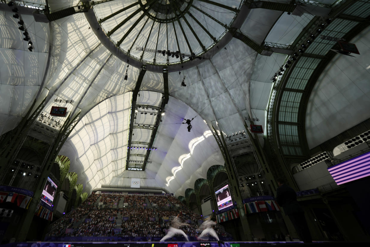 France's Sara Balzer, left, competes with Ukraine's Olga Kharlan in the women's individual Sabre semifinal match during the 2024 Summer Olympics at the Grand Palais, Monday, July 29, 2024, in Paris, France. (AP Photo/Andrew Medichini)