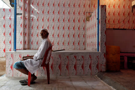 A member of the Qureshi community poses for a picture inside his butcher's shop, ordered to close, following regulations imposed by newly elected Uttar Pradesh State Chief Minister, Yogi Adityanath, in Lucknow, India, April 6, 2017. Picture taken April 6, 2017. REUTERS/Cathal McNaughton