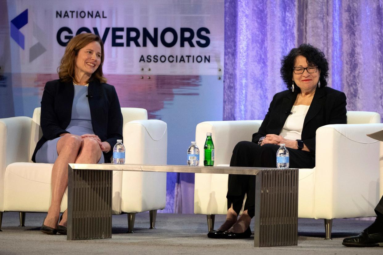 Supreme Court Justices Amy Coney Barrett, left, and Sonia Sotomayor speak with retired U.S. Appeals Court Judge Thomas Griffith, not shown, during a panel discussion at the winter meeting of the National Governors Association, Friday, Feb. 23, 2024 in Washington. (AP Photo/Mark Schiefelbein) ORG XMIT: DCMS103