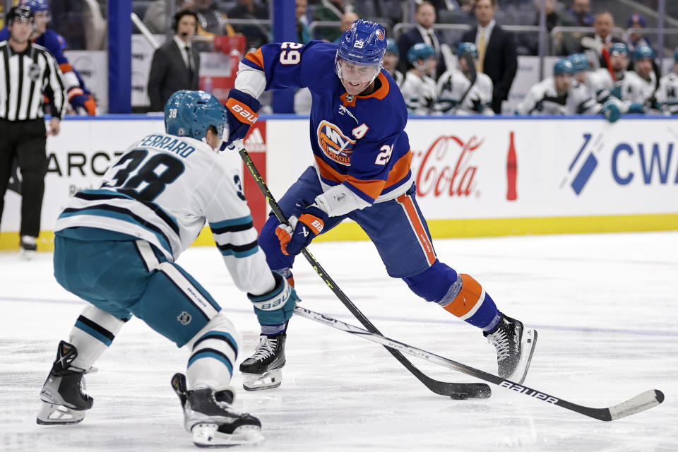 New York Islanders center Brock Nelson (29) shoots in front of San Jose Sharks defenseman Mario Ferraro during the second period of an NHL hockey game Tuesday, Dec. 5, 2023, in Elmont, N.Y. (AP Photo/Adam Hunger)