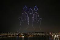 Drones fly over the Han river showing messages to support the country as measures to avoid the spread of the coronavirus disease (COVID-19) continue in Seoul