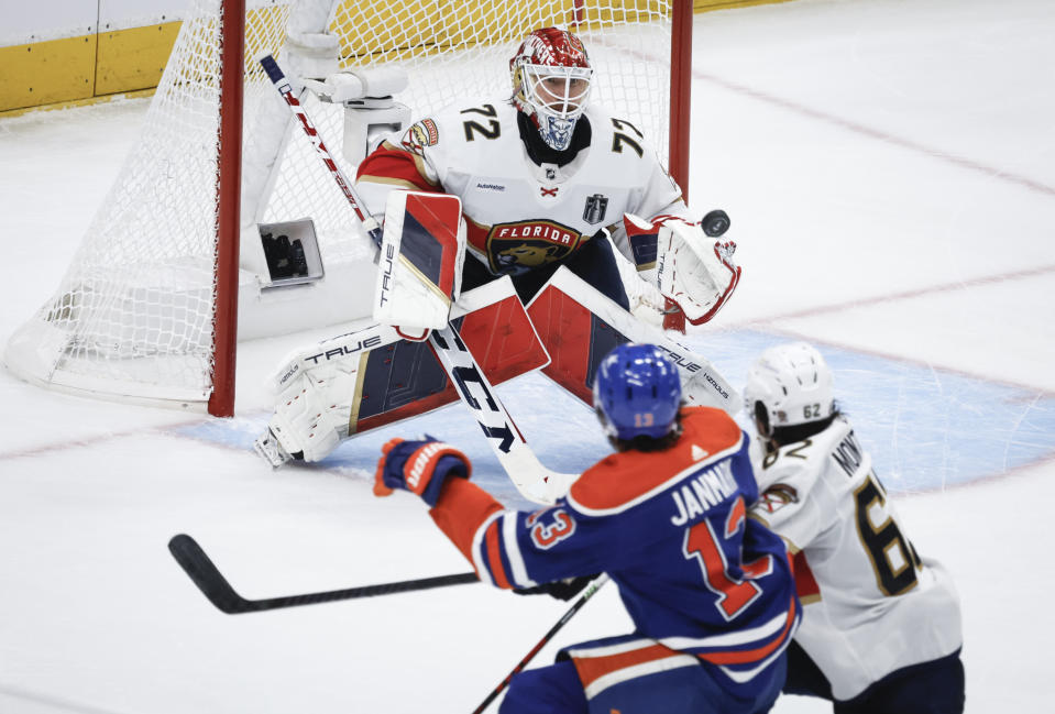 Florida Panthers goalie Sergei Bobrovsky (72) follows the puck as Brandon Montour (62) checks Edmonton Oilers' Mattias Janmark (13) during the second period of Game 6 of the NHL hockey Stanley Cup Final, Friday, June 21, 2024, in Edmonton, Alberta. (Jeff McIntosh/The Canadian Press via AP)