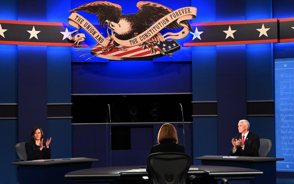 US Democratic vice presidential candidate Kamala Harris (L) and US Vice President Mike Pence applaud at the end of the vice presidential debate with US Vice President Mike Pence in Kingsbury Hall at the University of Utah on October 7, 2020, in Salt Lake City, Utah. (Photo by Eric BARADAT / AFP) (Photo by ERIC BARADAT/AFP via Getty Images)