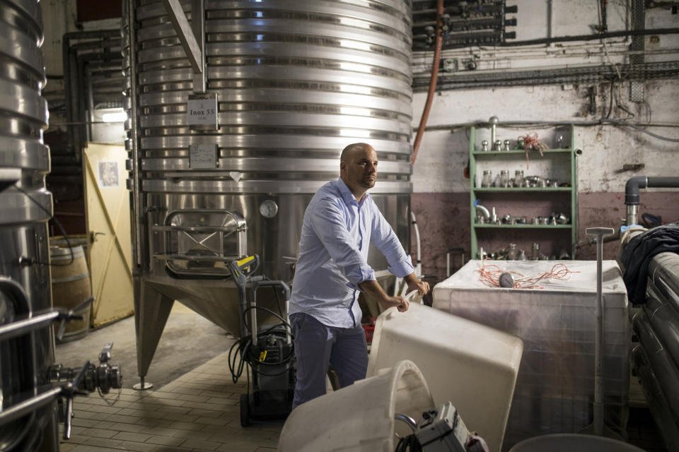 Sebastien Latz, director general of the French wine producer MDCV, poses in a wine production facility in the Chateau des Bertrands vineyard in Le Cannet-des-Maures, in the Provence region, Thursday Oct. 10, 2019. European producers of premium specialty agricultural products like French wine, Italian Parmesan and Spanish olives are facing Friday’s U.S. tariff hike with a mix of trepidation and indignation at being dragged into a trade war over the fiercely competitive aerospace industry. (AP Photo/Daniel Cole)