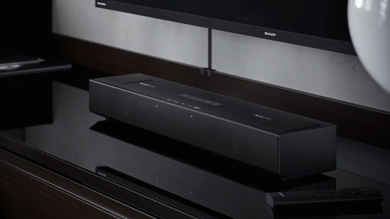  A Sharp soundbar sits in front a Sharp TV. 