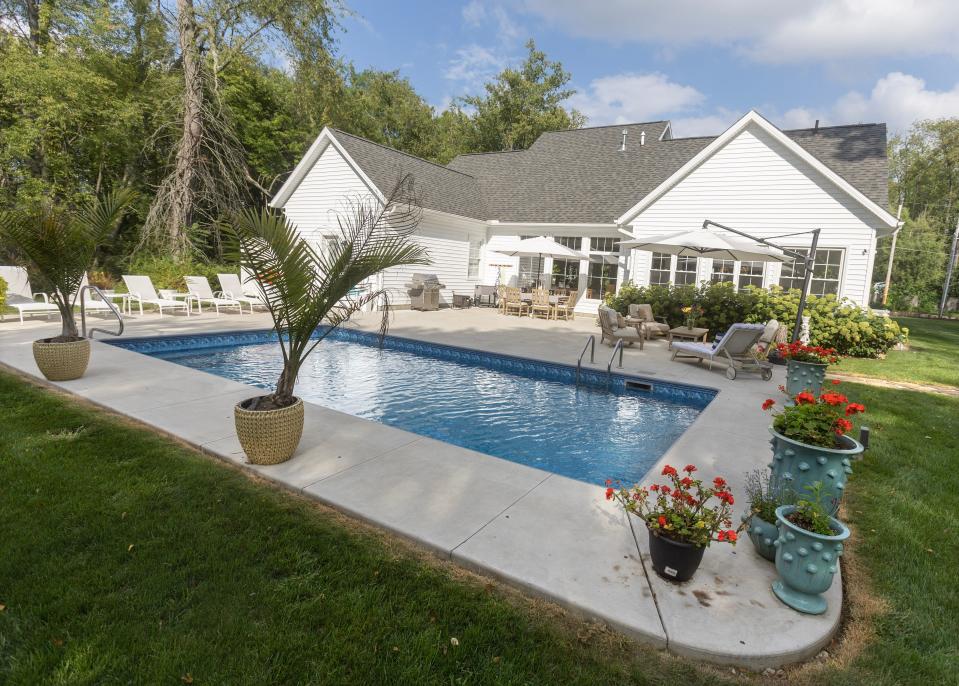 A pool is the centerpiece of the back yard of the modern farmhouse shared by Michael Kell and Sally Goodnow in Plain Township. The space also features a koi pond and fire pit.