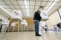 FILE - In this Oct. 20, 2020, file photo, Kelly Wingfield, of Urbandale, Iowa, fills out his ballot during early voting for the general election in Adel, Iowa. As it has for more than 170 years, The Associated Press will count the vote and report the results of presidential, congressional and state elections quickly, accurately and without fear or favor on Nov. 3 and beyond. (AP Photo/Charlie Neibergall, File)