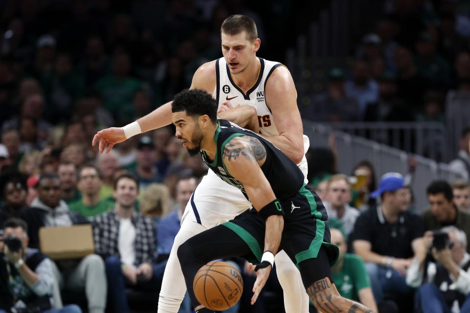 Boston Celtics' Jayson Tatum drives past Denver Nuggets' Nikola Jokic during the second half of an NBA basketball game, Friday, Nov. 11, 2022, in Boston. (AP Photo/Michael Dwyer)