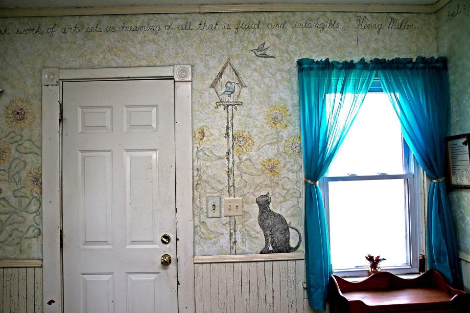 Nancy Lindsey-Janusz painted the art and phrase on the wall in the Victorian farmhouse. The quote, by Henry Miller, mentions art causing us to dream about "all that is fleeting and intangible."