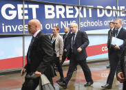 Britain's Prime Minister Boris Johnson, centre, arrives at the Conservative Party Conference in Manchester, England, Sunday Sept. 29, 2019. Johnson headed Sunday to the Conservative Party conference in Manchester, where the party is widely expected to endorse government plans to spend more on the country's National Health Service. (Stefan Rousseau/PA via AP)