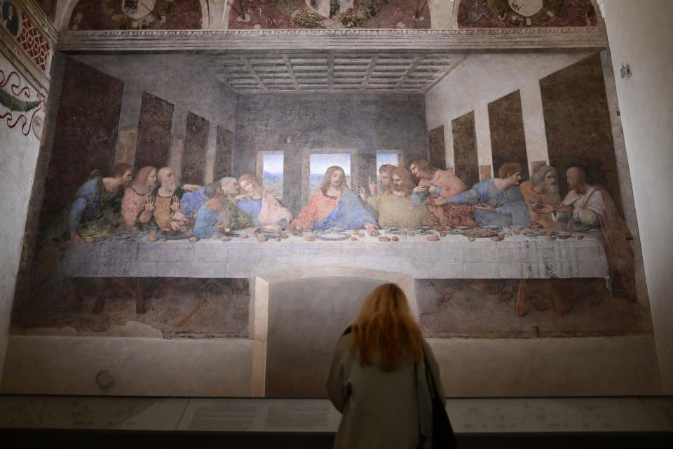 A visitor watches "The Last Supper" (Il Cenacolo or L'Ultima Cena), Italian artist Leonardo da Vinci's late 15th-century mural painting housed by the refectory of the Convent of Santa Maria delle Grazie in Milan, on February 10, 2021. The convent reopens to the public four days a week through February 9 - 21, 2021.