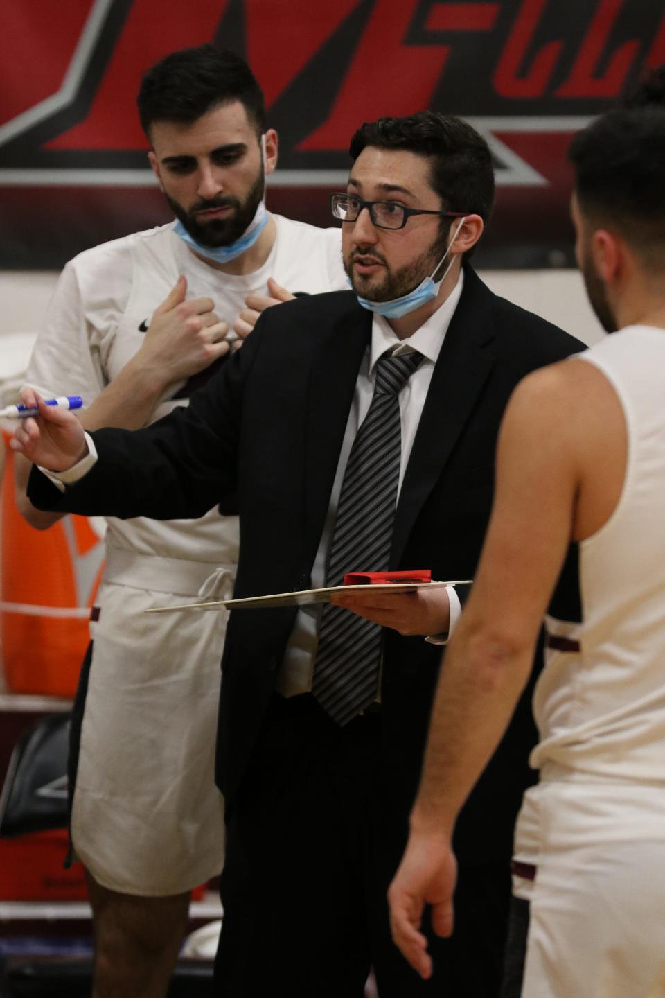 Sean McGee, 23, draws up a play during a timeout for his Manhattanville College men's basketball team in a Jan. 12, 2022 game against USMMA. The Poughquag native is an assistant who made his head coaching debut, filling in for Chris Alesi, who was quarantined with COVID-19.