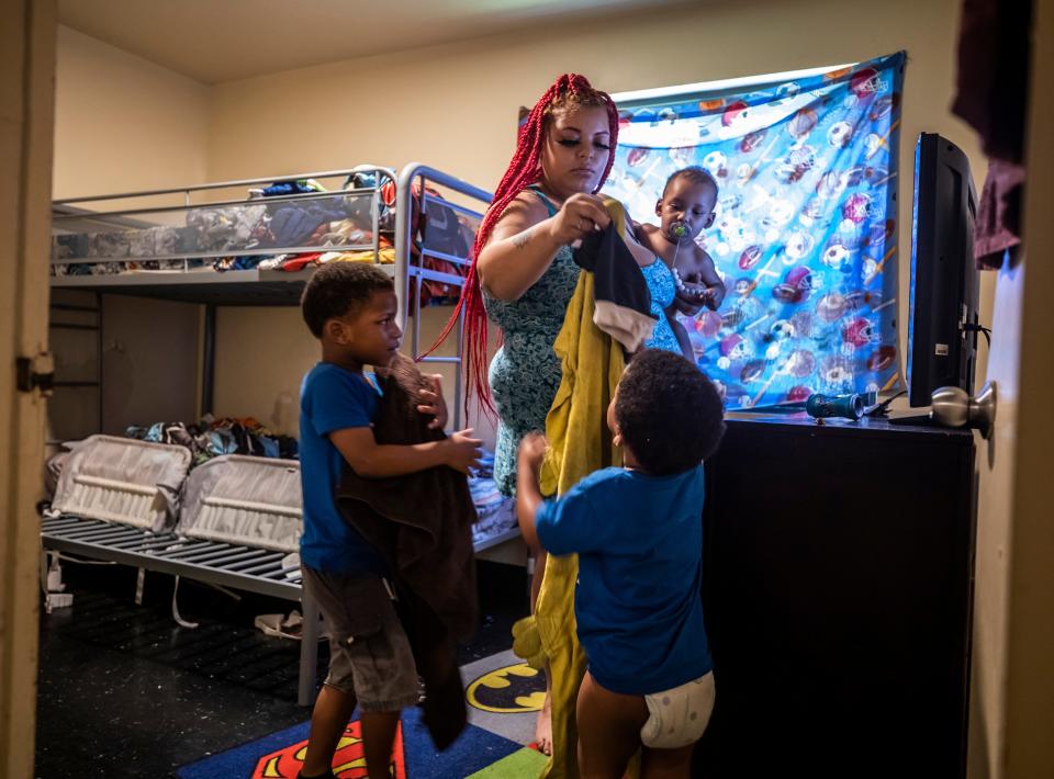 Lexus Ikeard, center, holding her son Troi Ensley, helps her other sons Travis and Noah Lawless get set up with clothes for after their baths at their residence in Nashville on Wednesday, August 25, 2021.