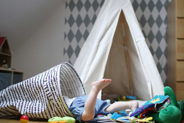 A 2 years old boy playing in his bedroom