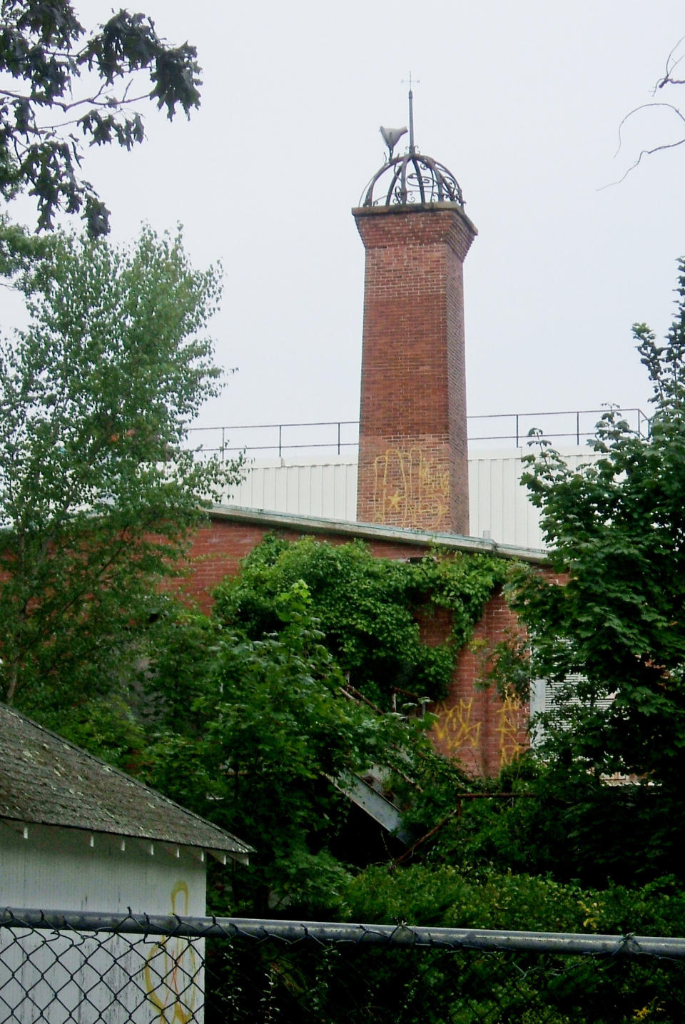 In this Thursday, Aug. 23, 2012 photo, a brick tower rises above the Shoreham, N.Y., building that was once the laboratory of physicist/inventor Nicola Tesla. In little more than a week, donors from more than 100 countries have kicked in about $1 million through a social media website to pay for the restoration of the 110-year-old laboratory built for the visionary scientist who experimented with wireless communication and envisioned a world of free electricity. (AP Photo/Frank Eltman)