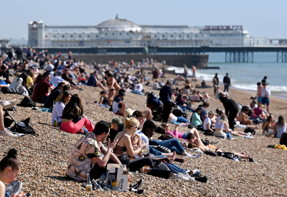 BRIGHTON, ENGLAND - MARCH 30:  Sunbathers enjoy the beach as a spell of hot weather coincides with lockdown restrictions being eased on March 30, 2021 in Brighton, England. Forecasters are predicting temperatures of 22C (72F), and with the easing of coronavirus lockdown rules many people will be heading for the outdoors. (Photo by Karwai Tang/Getty Images)