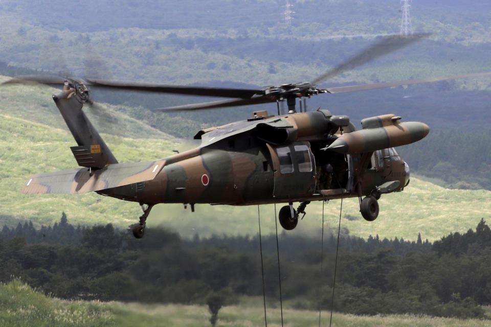 FILE - A UH-60JA helicopter is seen during an annual live firing exercise at Higashi Fuji range in Gotemba, on Aug. 25, 2016. A UH-60JA Black Hawk helicopter disappeared from radar on Thursday afternoon, April 6, 2023, while on a reconnaissance mission near Miyako island, the head of the Ground Self Defense Force, Yasunori Morishita, said at a news conference later that day. (AP Photo/Eugene Hoshiko, File)