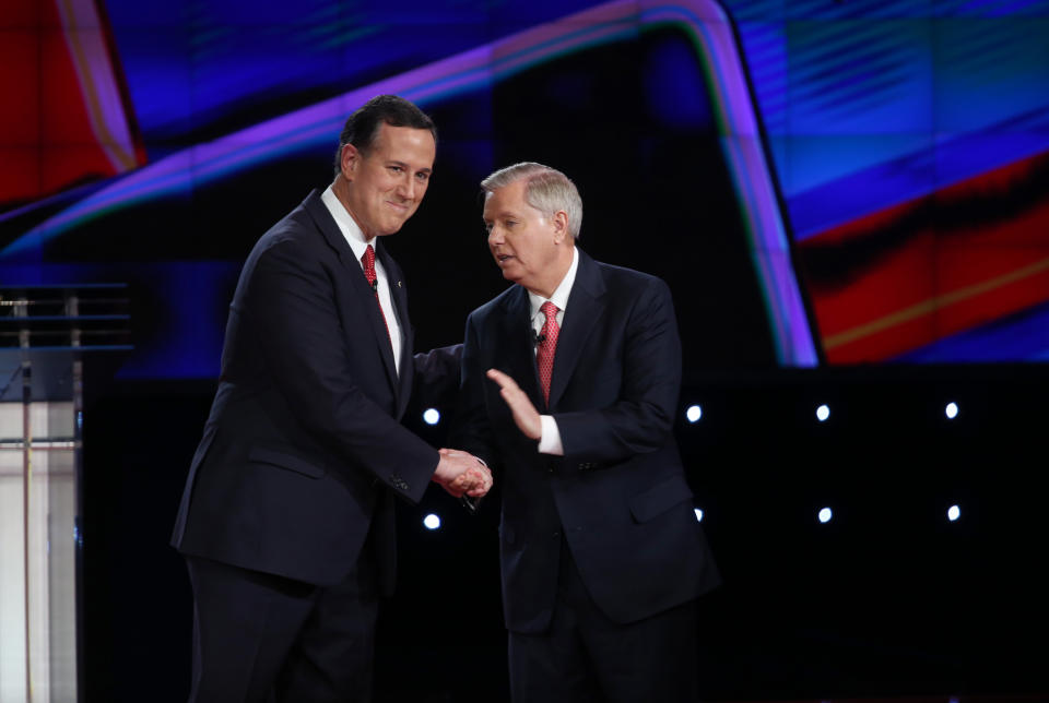 Republican presidential candidates George Pataki and Lindsey Graham shake hands before the CNN Republican presidential debate.