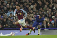 Aston Villa's Boubacar Kamara, left, runs with the ball past Chelsea's Enzo Fernandez during the English FA Cup fourth round soccer match between Chelsea and Aston Villa at the Stamford Bridge stadium in London, Friday, Jan. 26, 2024. (AP Photo/Kin Cheung)