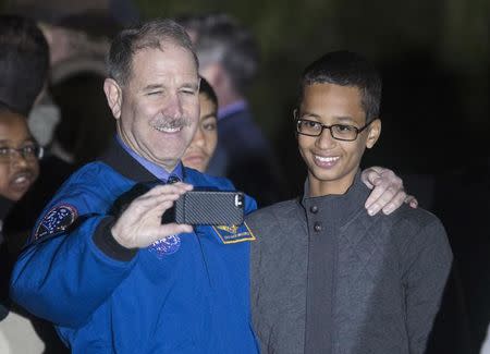 John M. Grunsfeld (L), Associate Administrator for the Science Mission Directorate, poses for a selfie with Ahmed Mohamed, 14, the Texas teenager who was arrested after bringing a homemade electronic clock to school, during the second White House Astronomy Night on the South Lawn of the White House in Washington October 19, 2015. REUTERS/Joshua Roberts
