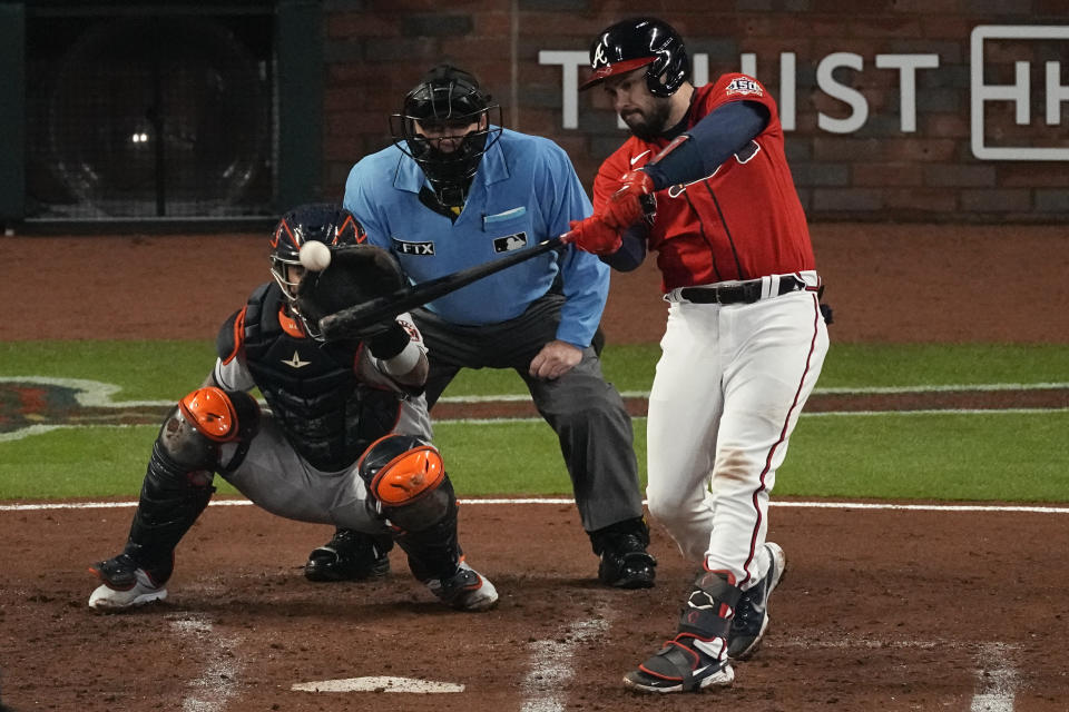 Atlanta Braves' Travis d'Arnaud hits a double during the second inning in Game 3 of baseball's World Series between the Houston Astros and the Atlanta Braves Friday, Oct. 29, 2021, in Atlanta. (AP Photo/John Bazemore)