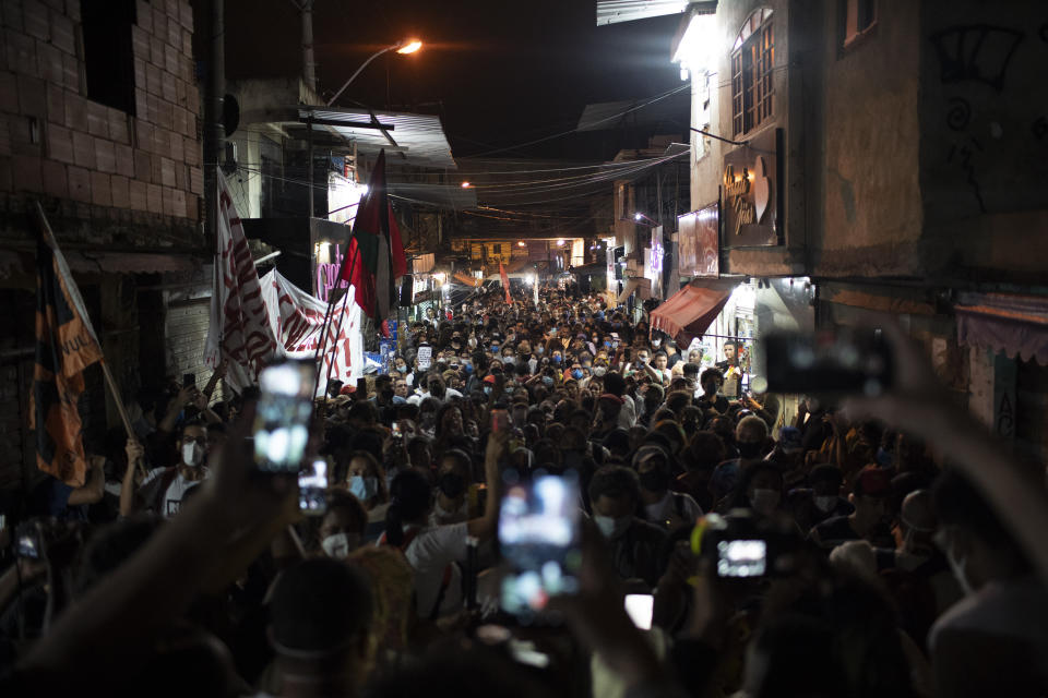 Relatives and residents protest a day after a deadly police operation in the Jacarezinho favela of Rio de Janeiro, Brazil, Friday, May 7, 2021. A bloody, hours-long gun battle here echoed into Friday, with authorities saying the police mission killed two dozen criminals while residents and activists claimed human rights abuses. (AP Photo/Silvia Izquierdo)