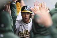 Oakland Athletics' Max Schuemann is congratulated for his solo home run off Cleveland Guardians starting pitcher Logan Allen, his first homer in the majors, during the fifth inning of a baseball game Saturday, April 20, 2024, in Cleveland. (AP Photo/Nick Cammett)