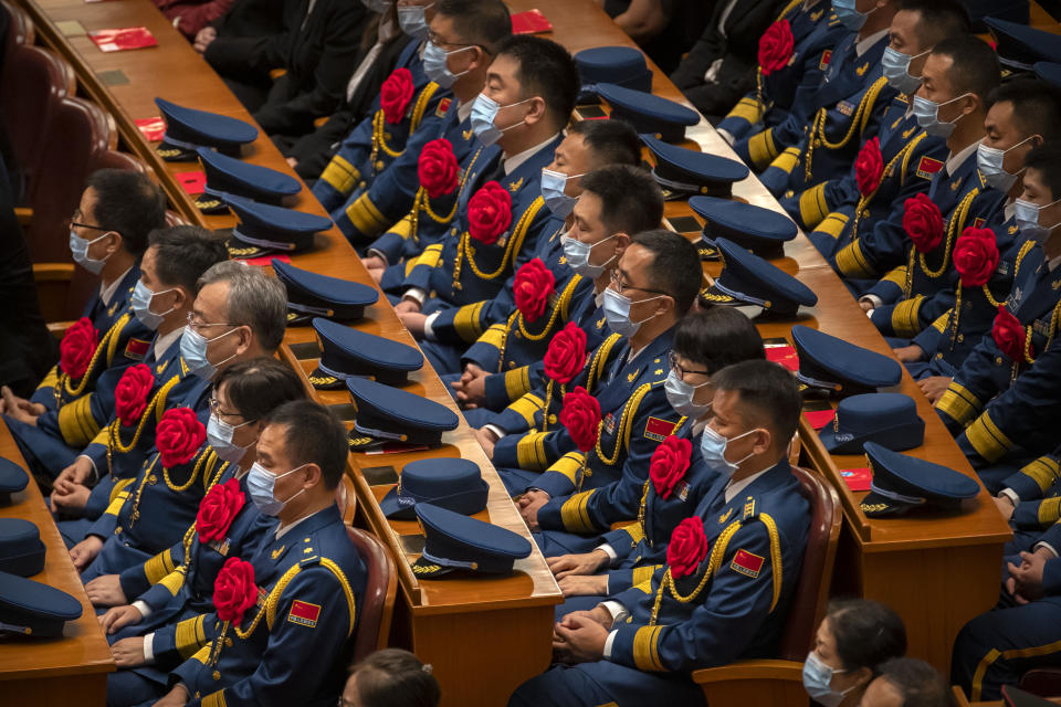 Military attendees wearing face masks watch an event to honor some of those involved in China's fight against COVID-19 at the Great Hall of the People in Beijing, Tuesday, Sept. 8, 2020. Chinese leader Xi Jinping is praising China's role in battling the global coronavirus pandemic and expressing support for the U.N.'s World Health Organization, in a repudiation of U.S. criticism and a bid to rally domestic support for Communist Party leadership. (AP Photo/Mark Schiefelbein)