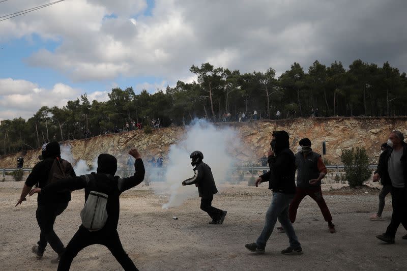 Demonstrators, who oppose the building of a new closed migrant detention centre, clash with riot police, in the area of Diavolorema on the island of Lesbos