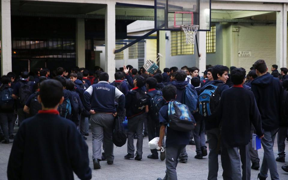 Students in Santiago are evacuated after the 7.1 magnitude quake - Credit: EPA