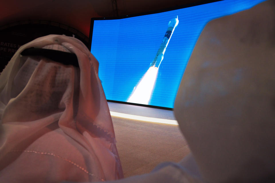 FILE - In this Monday, July 20, 2020 file photo, men watch the launch of the "Amal" or "Hope" space probe at the Mohammed bin Rashid Space Center in Dubai, United Arab Emirates. The orbiter is scheduled to reach Mars on Tuesday, Feb. 9, 2021, followed less than 24 hours later by China’s orbiter-rover combo. NASA’s rover will arrive on the scene a week later, on Feb. 18, to collect rocks for return to Earth _ a key step in determining whether life ever existed at Mars. (AP Photo/Jon Gambrell)