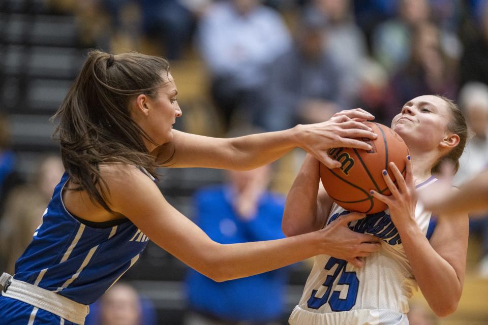 Franklin Community High School junior Scarlett Kimbrell (13) attempts to stop a drove by Columbus North High School sophomore Hadassah Hurt (35) during the first half of an IHSAA Girlsâ€™ Sectional basketball game, Tuesday, Jan. 31, 2023, at Shelbyville High School.