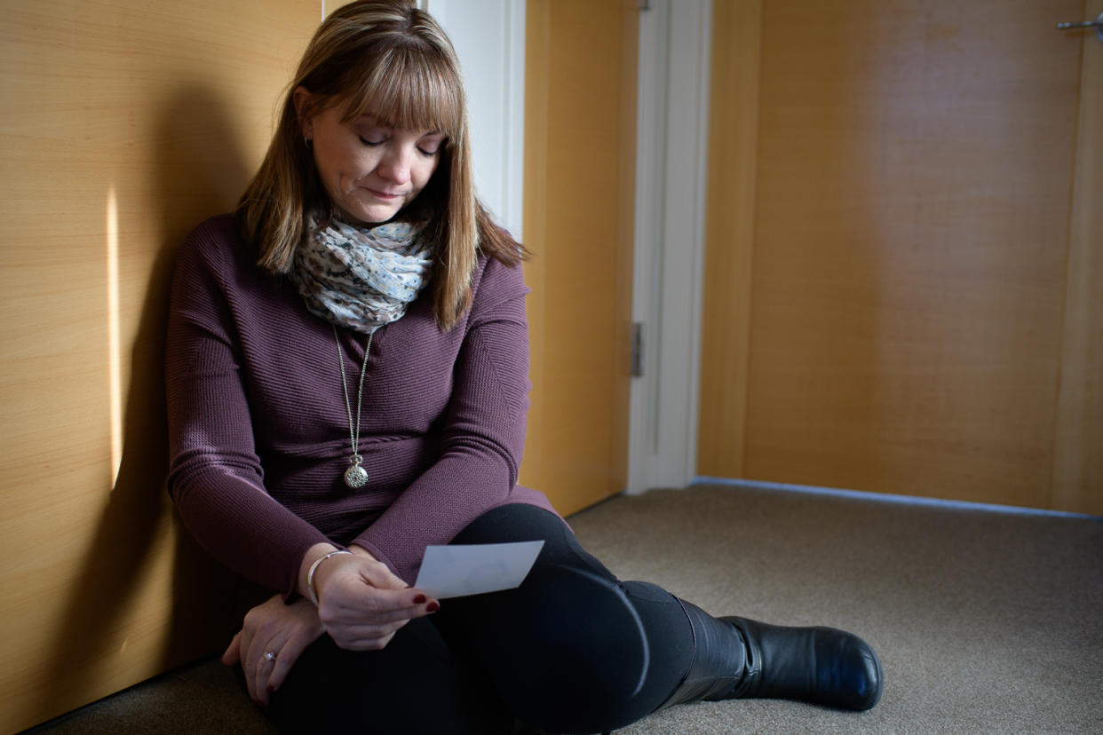 Coni Sanders looks at a photo of her father, William “Dave” Sanders, who was killed in the Columbine shooting. (Photo: Carl Bower for Yahoo News)