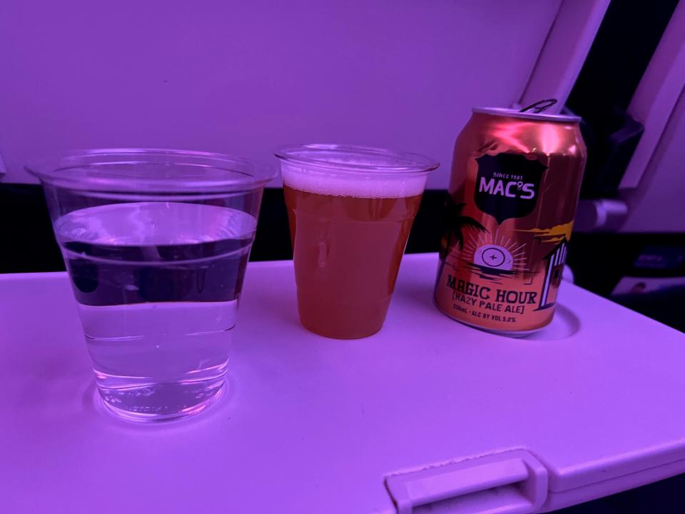 Beer and water on the tray table next to me.