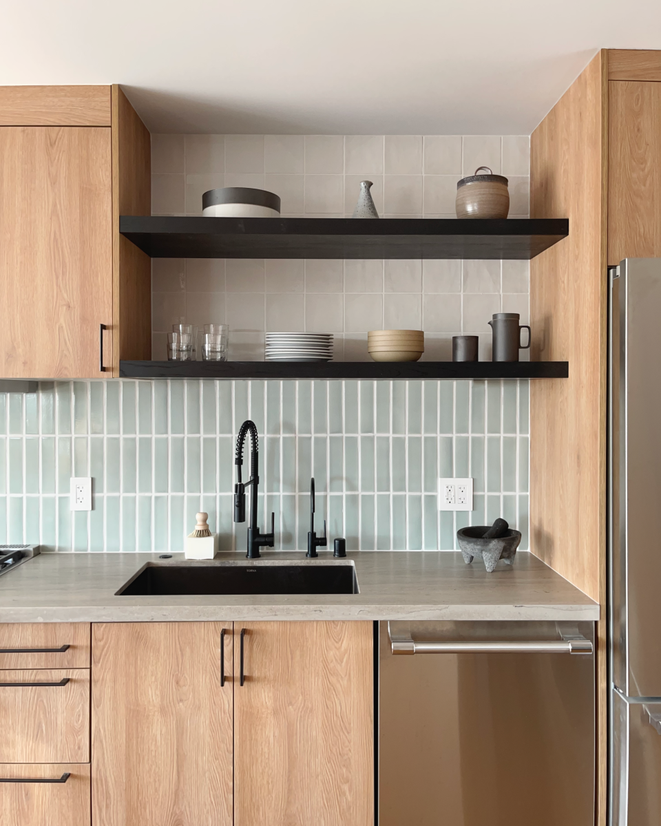 Two tiers of blue and white kitchen tiles add layers of visual interest to this Alter Interiors design project.